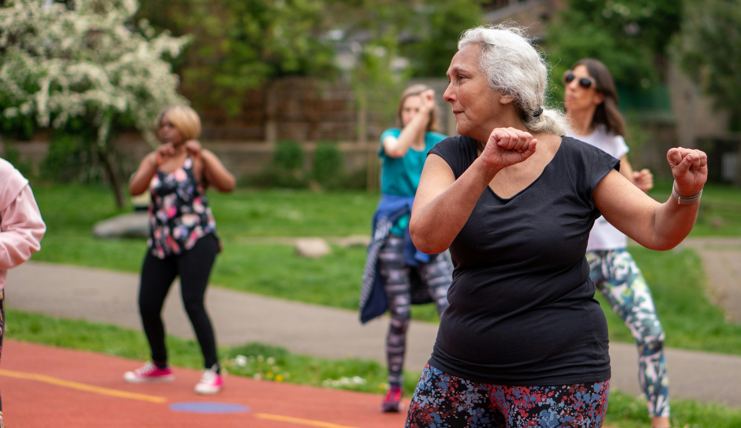 A woman leading a fitness class with older adults.