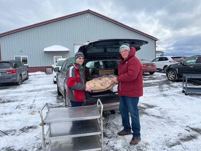 Dan Balch and Eric Weidner loading potatoes destined for Lakeshore Community Pantry
